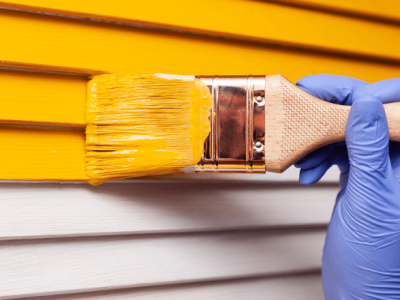 closeup-female-hand-purple-rubber-glove-with-paintbrush-painting-natural-wooden-door-with-orange-paint-colored-bright-creative-design-interior-how-pa